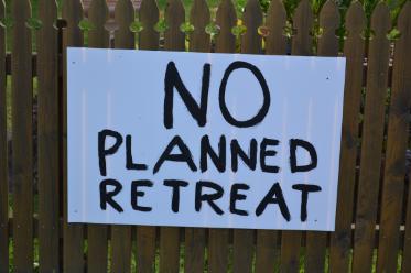 This poster along a fence on Illaroo Road exemplifies the public's disaproval of the planned retreat option. 